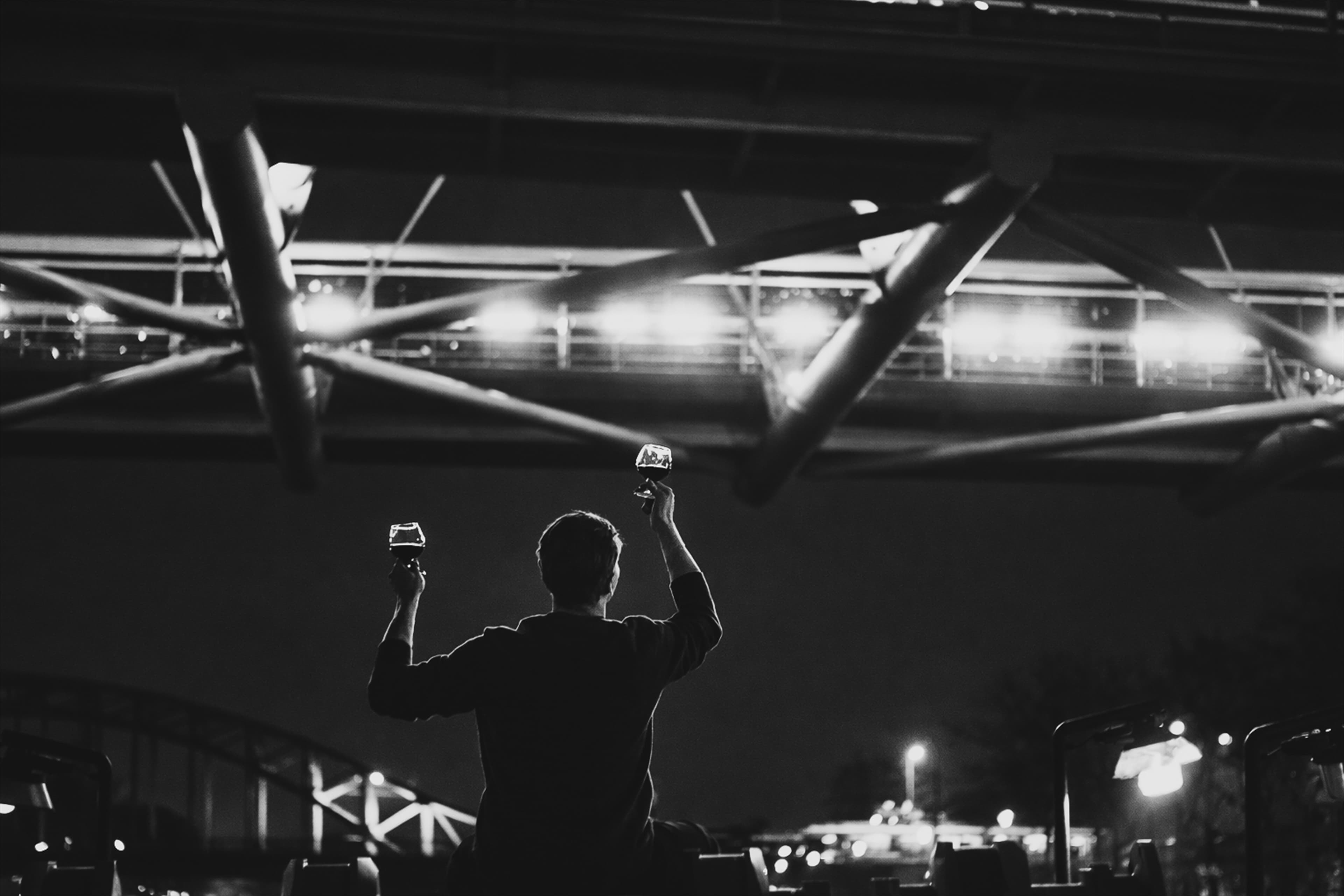 Black and white night scene below a bridge