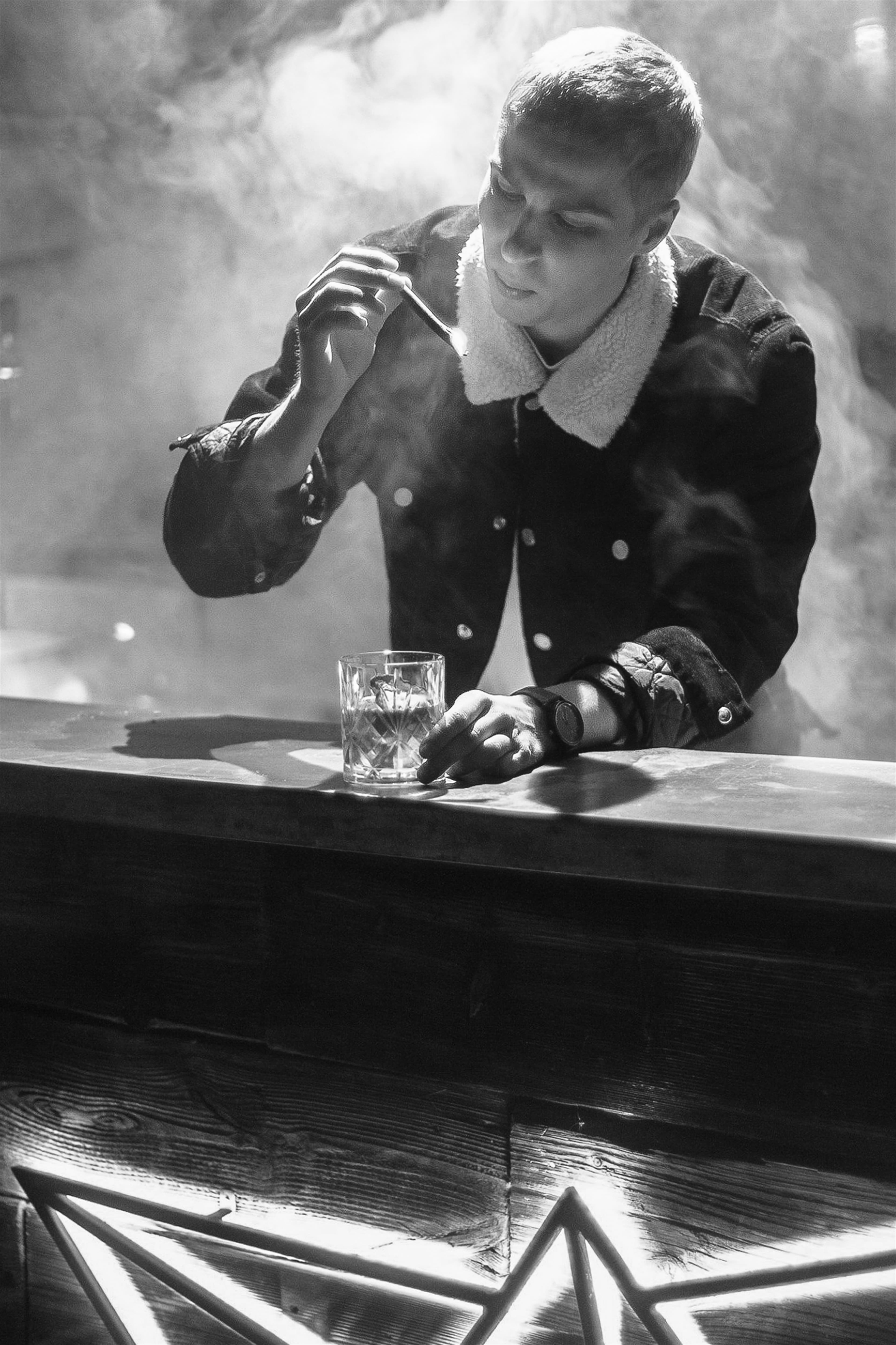 Black and white portrait at a bar with smoke